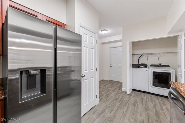 kitchen with appliances with stainless steel finishes and washing machine and dryer