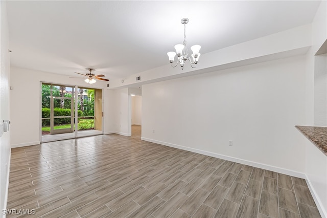 unfurnished living room with light wood-type flooring and ceiling fan with notable chandelier