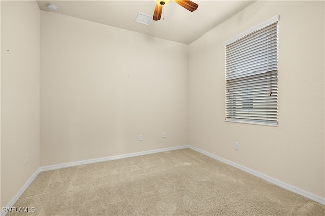 unfurnished room featuring ceiling fan and light carpet