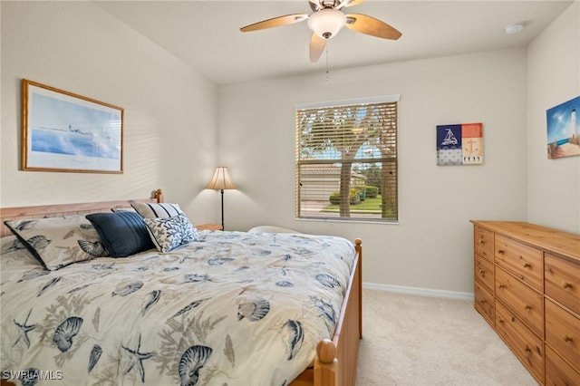 bedroom featuring light carpet and ceiling fan