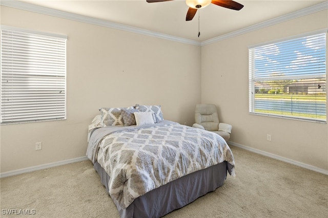 carpeted bedroom with ceiling fan and crown molding