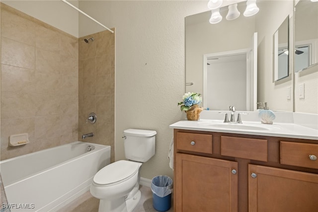 full bathroom with vanity, toilet, and tiled shower / bath