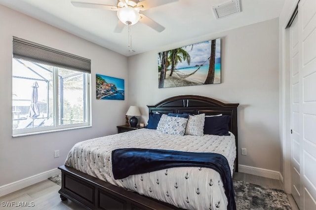 bedroom with hardwood / wood-style flooring, a closet, and ceiling fan