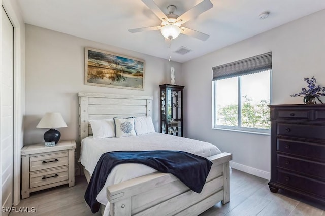 bedroom with ceiling fan and light hardwood / wood-style floors