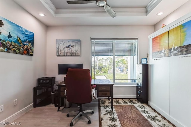 office with a raised ceiling, ornamental molding, ceiling fan, and light hardwood / wood-style floors