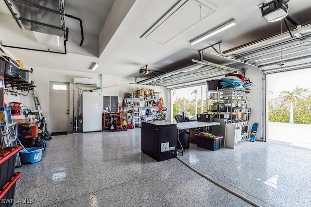 garage featuring a garage door opener, a wall mounted AC, and white refrigerator