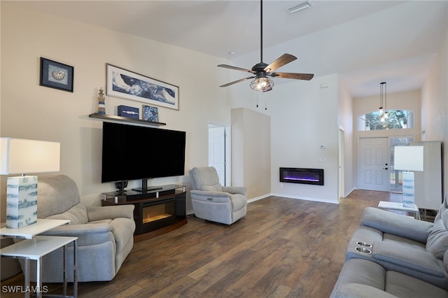 living room with high vaulted ceiling and dark hardwood / wood-style floors