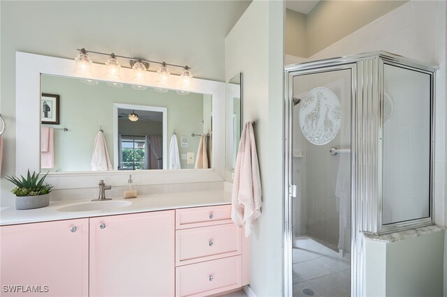 bathroom with tile patterned floors, vanity, and an enclosed shower