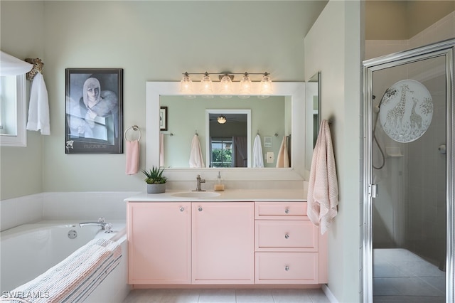 bathroom with tile patterned flooring, vanity, and independent shower and bath