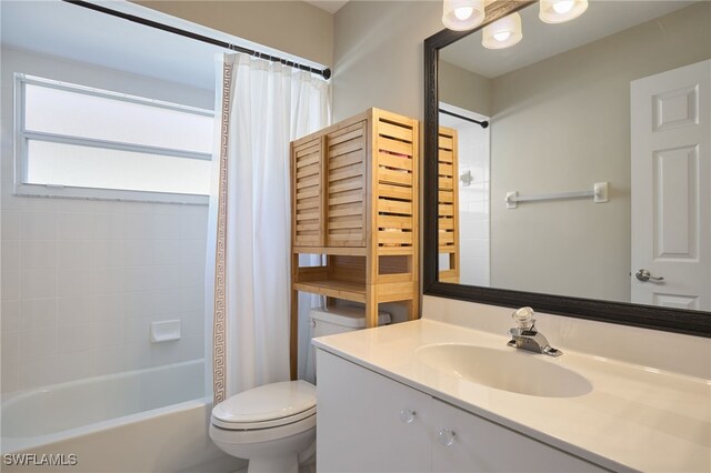 full bathroom with vanity, shower / bath combination with curtain, and toilet