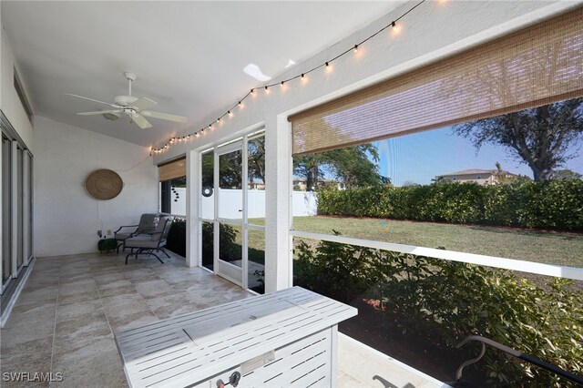 sunroom / solarium featuring ceiling fan