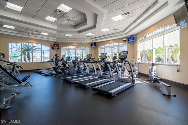 workout area with a paneled ceiling and ceiling fan