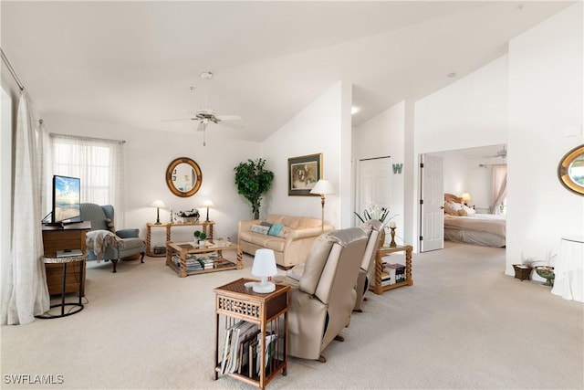 living room with ceiling fan, light colored carpet, and lofted ceiling