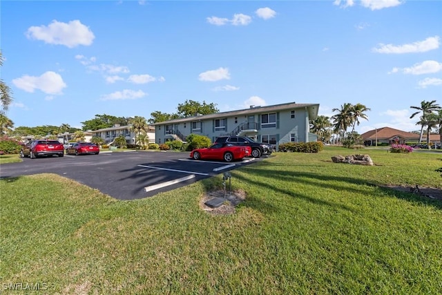 view of vehicle parking featuring a yard