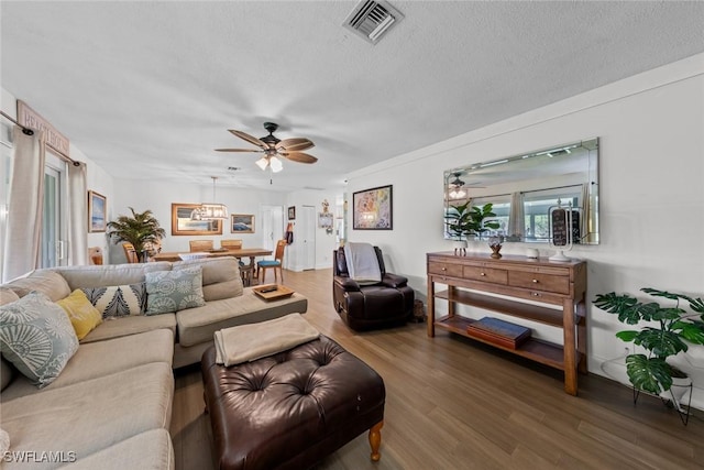 living room with ceiling fan, wood-type flooring, and a textured ceiling