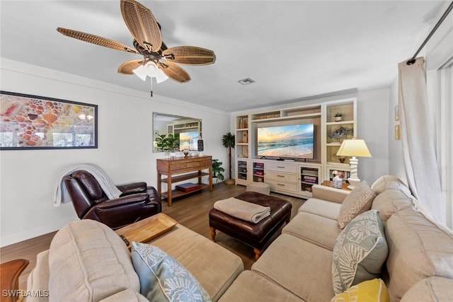 living room featuring ceiling fan and hardwood / wood-style floors