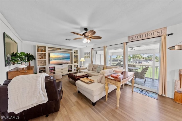 living room with ceiling fan and light wood-type flooring