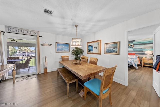 dining space with hardwood / wood-style floors