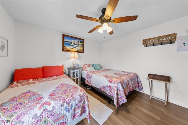 bedroom featuring ceiling fan and dark wood-type flooring