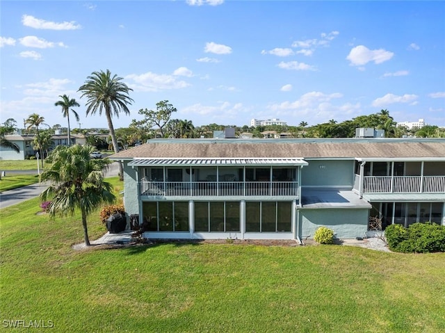 rear view of property featuring a yard