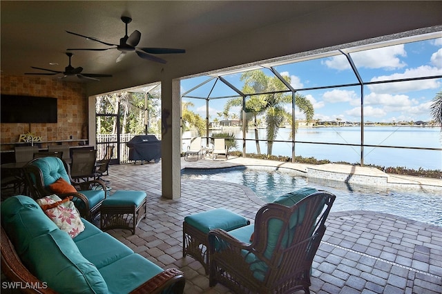 view of patio with an outdoor living space, ceiling fan, a water view, exterior bar, and a grill