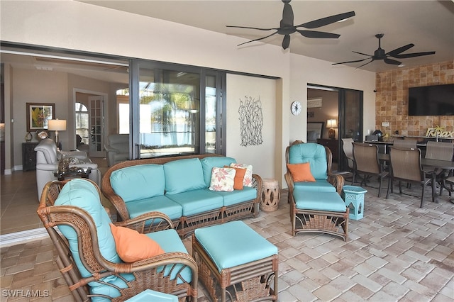 view of patio / terrace with outdoor dining area, an outdoor living space, and a ceiling fan