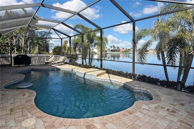 view of swimming pool with a patio area, a lanai, and a water view