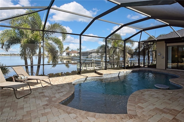 view of swimming pool featuring glass enclosure, a water view, and a patio area