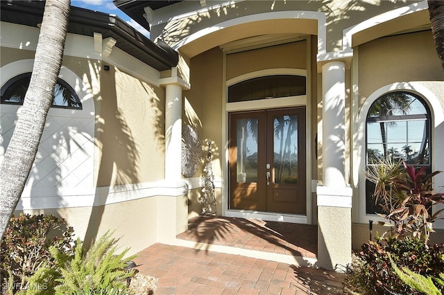 entrance to property with french doors and stucco siding