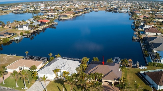 drone / aerial view featuring a water view and a residential view