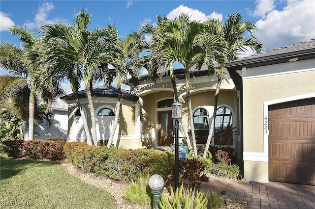 mediterranean / spanish-style house featuring a garage and stucco siding