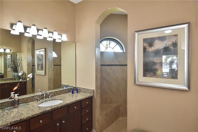 bathroom featuring vanity and a tile shower