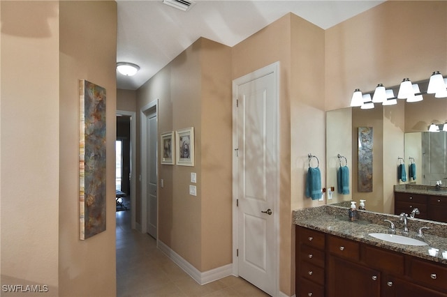 bathroom featuring visible vents, tile patterned floors, baseboards, and vanity