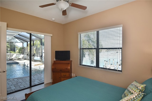 bedroom with ceiling fan, tile patterned floors, and access to outside