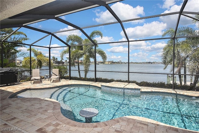 outdoor pool featuring a lanai, a water view, and a patio area