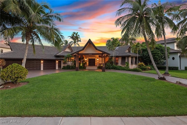 view of front facade with a garage and a yard