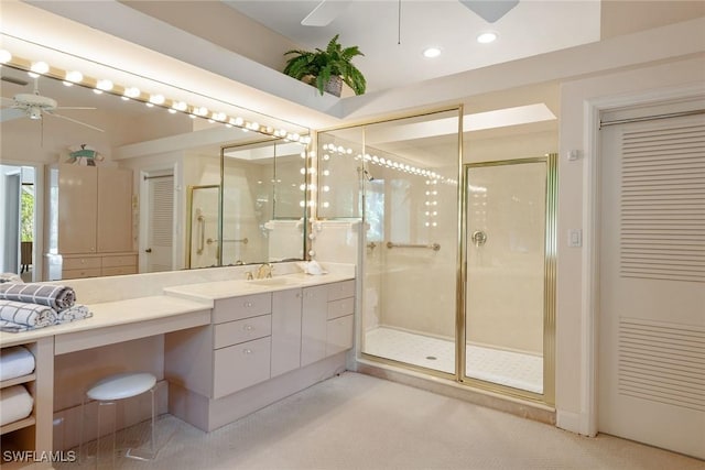 bathroom featuring walk in shower, vanity, and ceiling fan