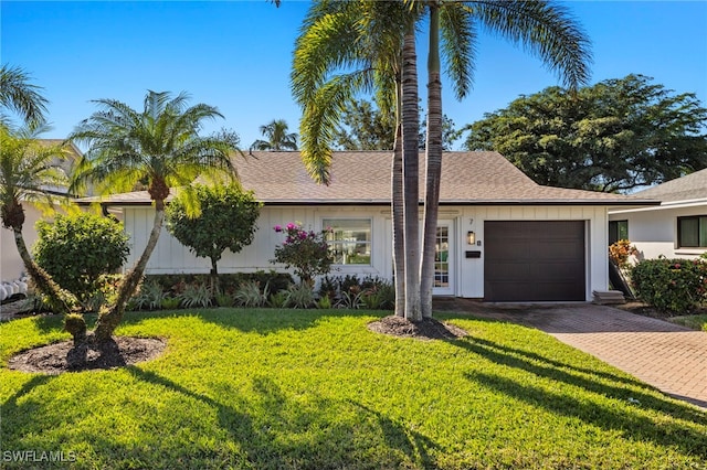 view of front of house featuring a front yard and a garage