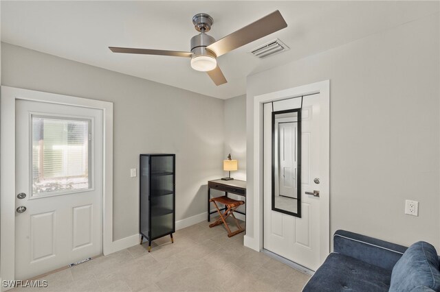 living area featuring ceiling fan