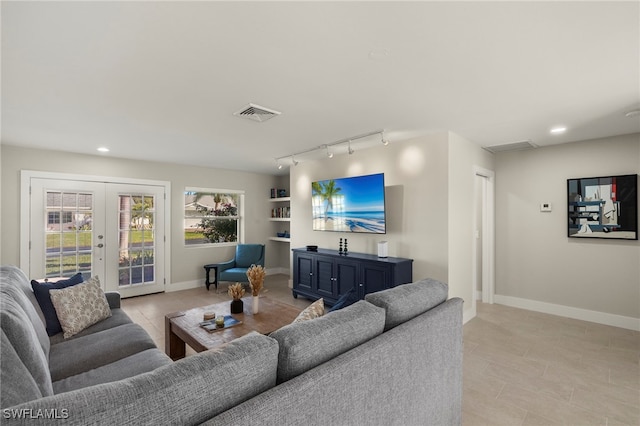 living room featuring french doors and rail lighting