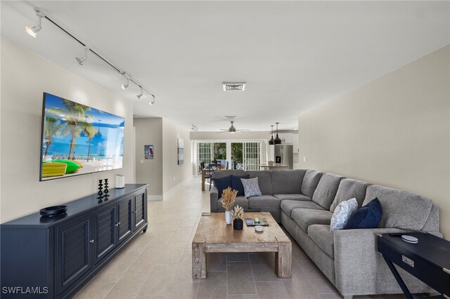 living room with ceiling fan and light tile patterned floors