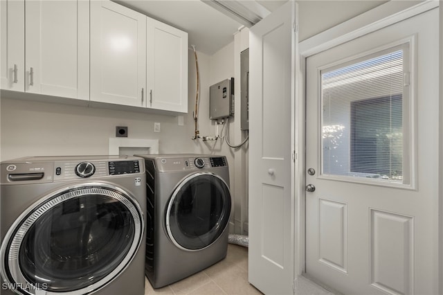 washroom with cabinets, light tile patterned floors, and separate washer and dryer