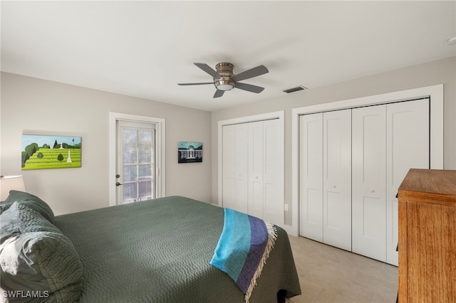 bedroom featuring ceiling fan and two closets