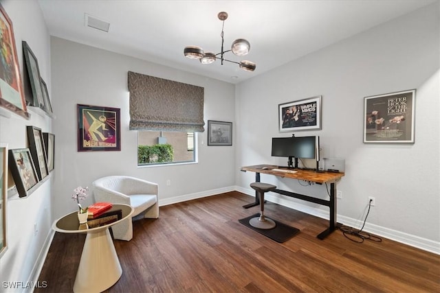 office area with dark wood-type flooring and an inviting chandelier