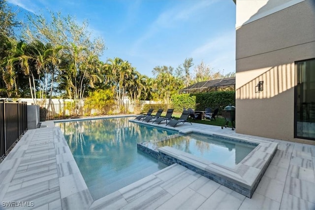 view of pool with an in ground hot tub and a patio area