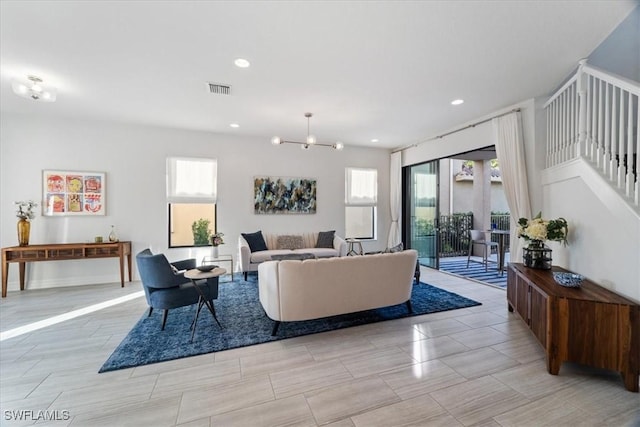 living room featuring a chandelier and a healthy amount of sunlight