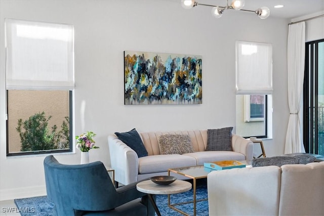 living room featuring a chandelier and plenty of natural light