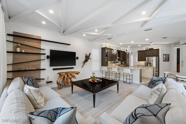 living room featuring lofted ceiling with beams and light wood-type flooring