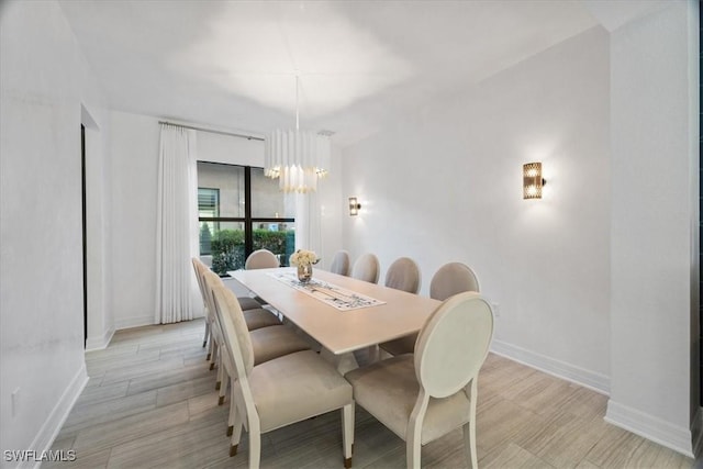 dining room featuring an inviting chandelier and light hardwood / wood-style flooring