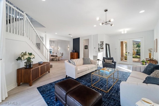 living room with an inviting chandelier and french doors